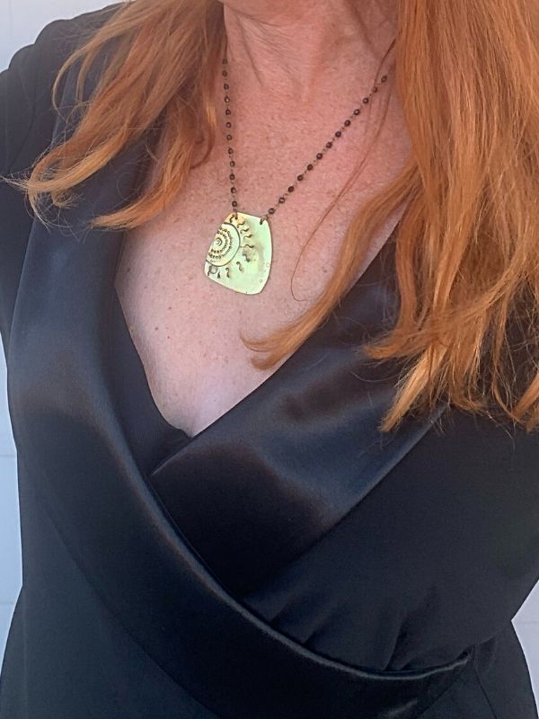 black top gold sun necklace